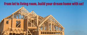 Partially built wooden frame of a house under construction with a blue sky.